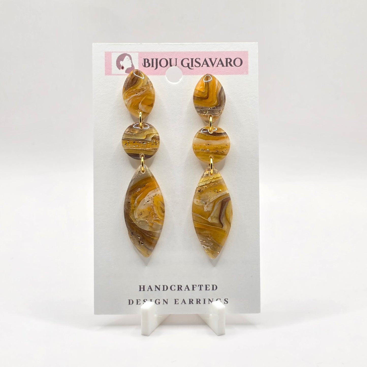 De Golden Amber Marble Statement oorbellen zijn handgemaakt en hebben een warme, luxueuze uitstraling. Het gemarmerde patroon combineert tinten van okergeel, amber, bruin, crème en subtiele goudaccenten, waardoor ieder paar een uniek karakter heeft.
Het elegante driedelige ontwerp met organische vormen zorgt voor een opvallende statement look, terwijl de oorbellen met slechts 2,7 gram per oorbel aangenaam licht zijn om te dragen.
Details
Handgemaakt
Kleur: amber, okergeel, bruin & crème
Goudkleurige deta