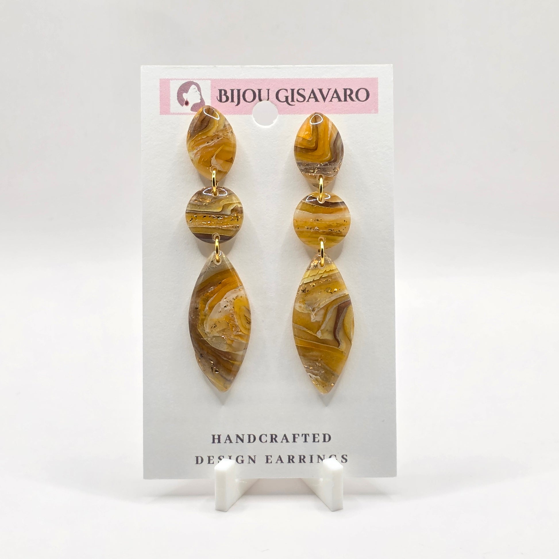 De Golden Amber Marble Statement oorbellen zijn handgemaakt en hebben een warme, luxueuze uitstraling. Het gemarmerde patroon combineert tinten van okergeel, amber, bruin, crème en subtiele goudaccenten, waardoor ieder paar een uniek karakter heeft.

Het elegante driedelige ontwerp met organische vormen zorgt voor een opvallende statement look, terwijl de oorbellen met slechts 2,7 gram per oorbel aangenaam licht zijn om te dragen.

Details

Handgemaakt
Kleur: amber, okergeel, bruin & crème
Goudkleurige deta