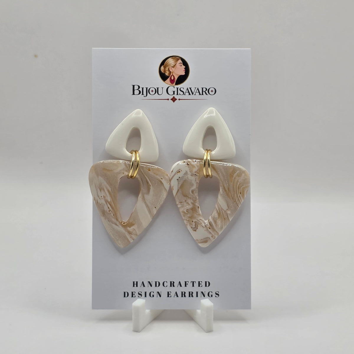 De Statement oorbellen Ivory Pearl zijn handgemaakte oorbellen met een elegante en verfijnde uitstraling. De combinatie van ivoorwit, parelmoer, crème en subtiele goudaccenten geeft deze oorbellen een zachte, luxueuze look.

Het dubbele open ontwerp met organische driehoekvormen en goudkleurige verbindingsringen maakt ze bijzonder en stijlvol. Door het handgemaakte patroon is ieder paar uniek.

Details

Handgemaakt
Kleur: ivoorwit, crème &amp; parelmoer
Subtiele goudaccenten
Open geometrisch design
Len